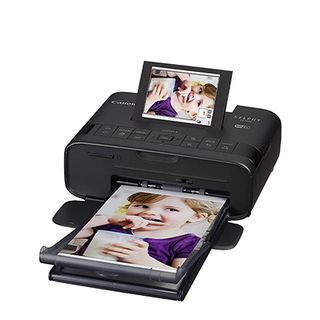 A press shot of the Canon SELPHY CP1300 art printer.