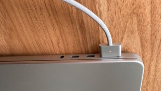 A MacBook Pro being charged my MagSafe charger