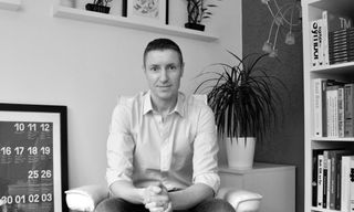 Black and white photograph of author David Airey in office