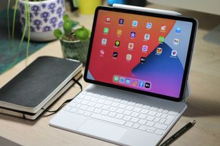 The iPad Pro 11-inch 2021, one of the latest iPad Pros in the iPad generations list, with Magic keyboard and Apple Pencil