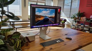 Apple Studio Display, one of the best monitors for working from home, on a desk in an office