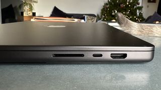 A Space Black Apple MacBook Pro 16-inch M3 sitting on a grey/blue table