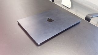 MacBook Air laptop in an office on a black desk