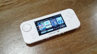 best retro game consoles; a white handheld games console on a wooden table