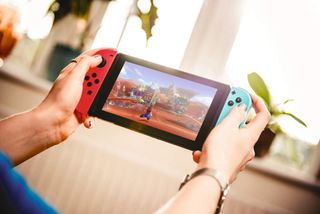 Detail of a young woman playing video games on a Nintendo Switch home console