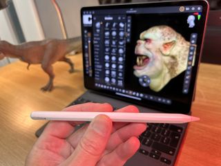 ZBrush for iPad: everything you need to know; a person holds an Apple Pencil