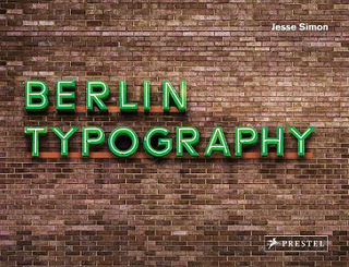 Berlin Typography book cover with neon green lettering on red brick wall