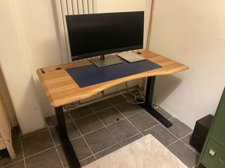 A FlexiSpot E7 Pro standing desk in a small home office