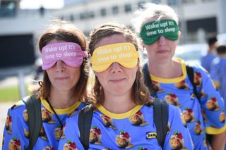 Three women wearing masks that read 'Wake up! It's time to sleep" in sans-serif font