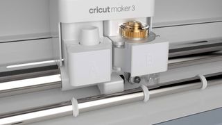 Cricut Explore 3 vs Cricut Maker 3; a close up of a craft machine's cutting tool