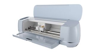 Cricut Explore 3 vs Cricut Maker 3; a white coloured craft machine with its lid open