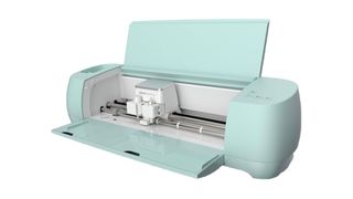 Cricut Explore 3 vs Cricut Maker 3; a mint coloured craft machine with its lid open