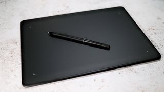 Huion Inspiroy Frego M review; An image of the Huron Frego M, with its accompanying stylus.