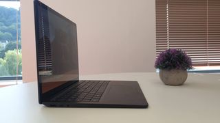 Surface Laptop 5 on a wooden table in an office