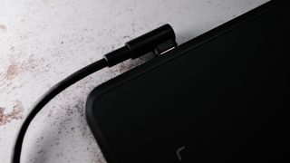 Huion Inspiroy Frego M review; A right angled USB-C connector, plugged into the Frego M