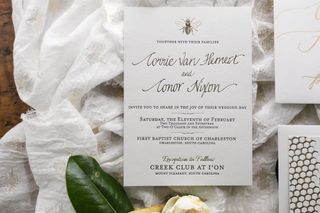 Photograph of a wedding invitation with a script font used for the couple's names