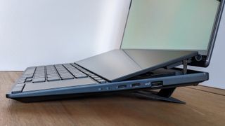 An Asus Zenbook Pro 14 Duo OLED laptop on a wooden desk