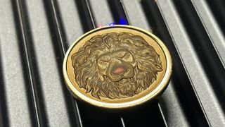 An embossed coin, showing a lion's head, made on the F1 Ultra.