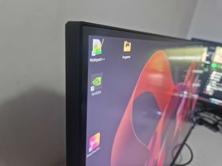 A Gigabyte M27U monitor on a white desk