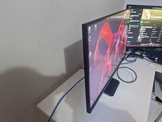 A Gigabyte M27U monitor on a white desk