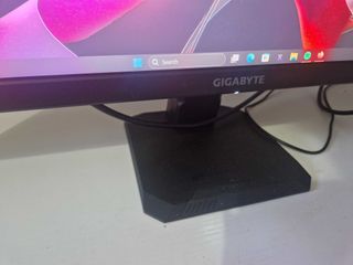 A Gigabyte M27U monitor on a white desk