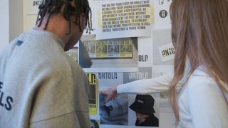 Here Design process of creating Untold identity with young male prisoners - people looking at a mood board